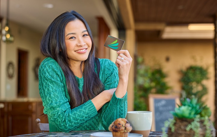 Woman holding a credit card.