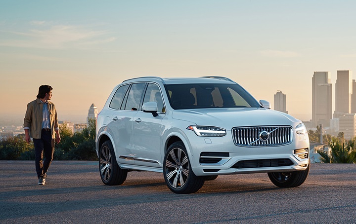 Someone walking around a Volvo